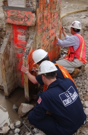 U.S. Coast Guard Petty Officer David M. Bittle (center) signs the Last Column, May 28, 2002. Photograph by Public Affairs Specialist Second Class Tom Sperduto, U.S. Coast Guard.