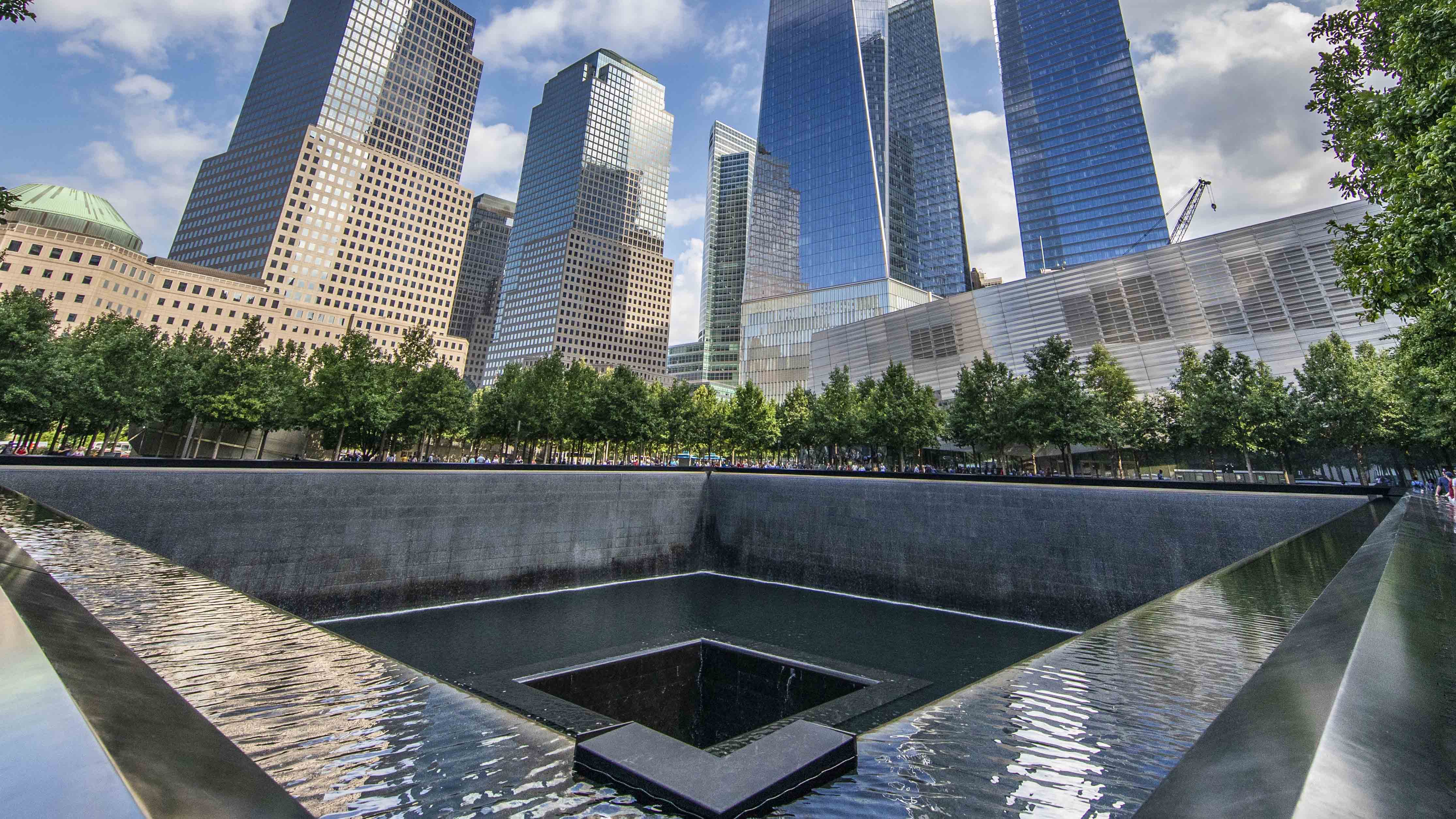 This panoramic shot is taking from southeast corner of the north pool of the Memorial, looking northward and upward toward the soaring One World Trade.