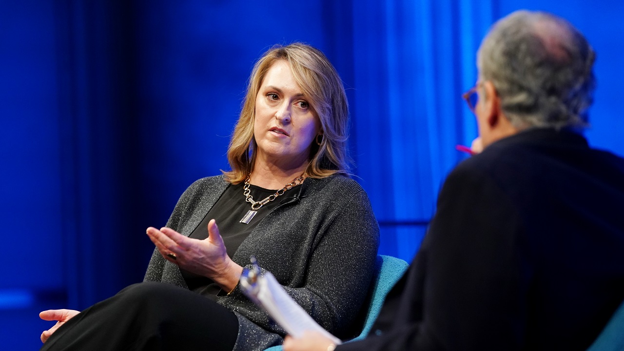 Author and former CIA analyst and targeting officer Nada Bakos sits onstage with Clifford Chanin, the executive vice president and deputy director for museum programs, as she takes part in a public program in the Museum Auditorium. Bakos gestures with her left and right hand as she looks at Chanin while speaking.