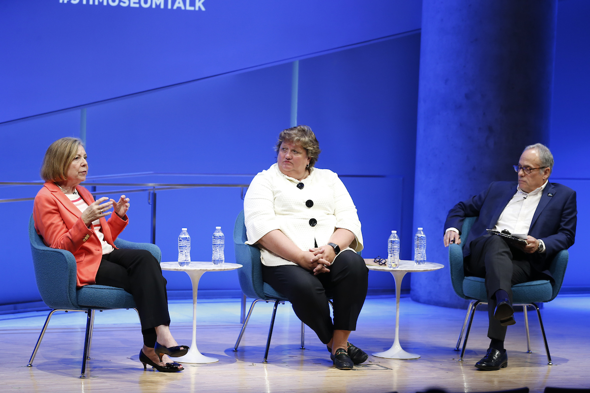 Three panelists on stage