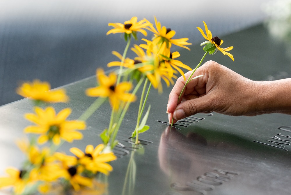 Yellow flower tributes are left on the Memorial.