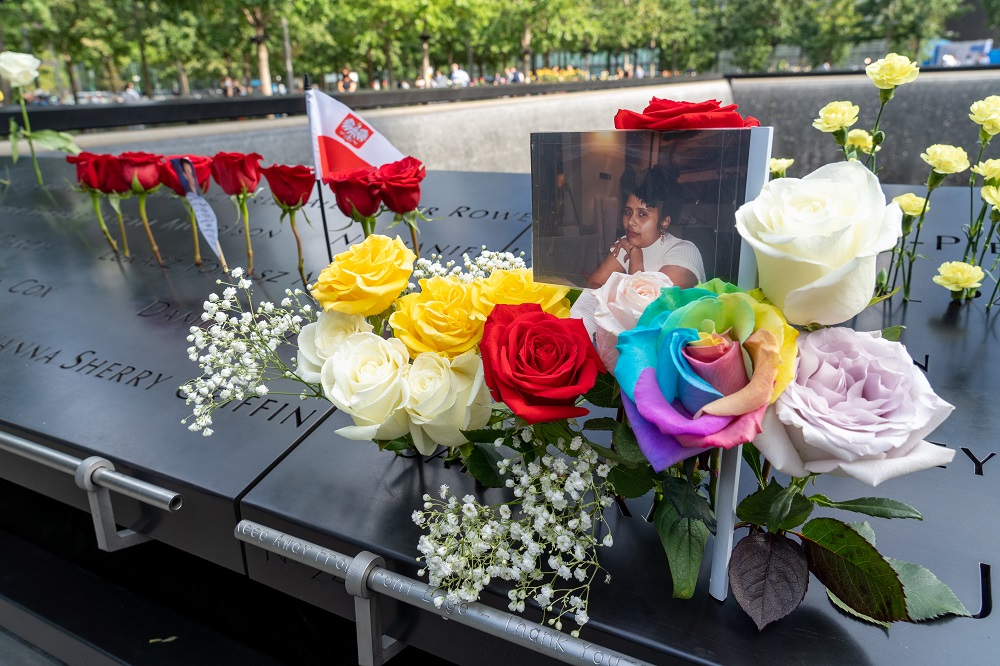 Mulitcolor flower tributes are left on the Memorial