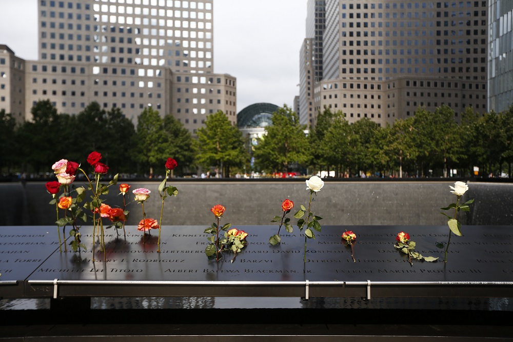 Flower tributes are left on the memorial.