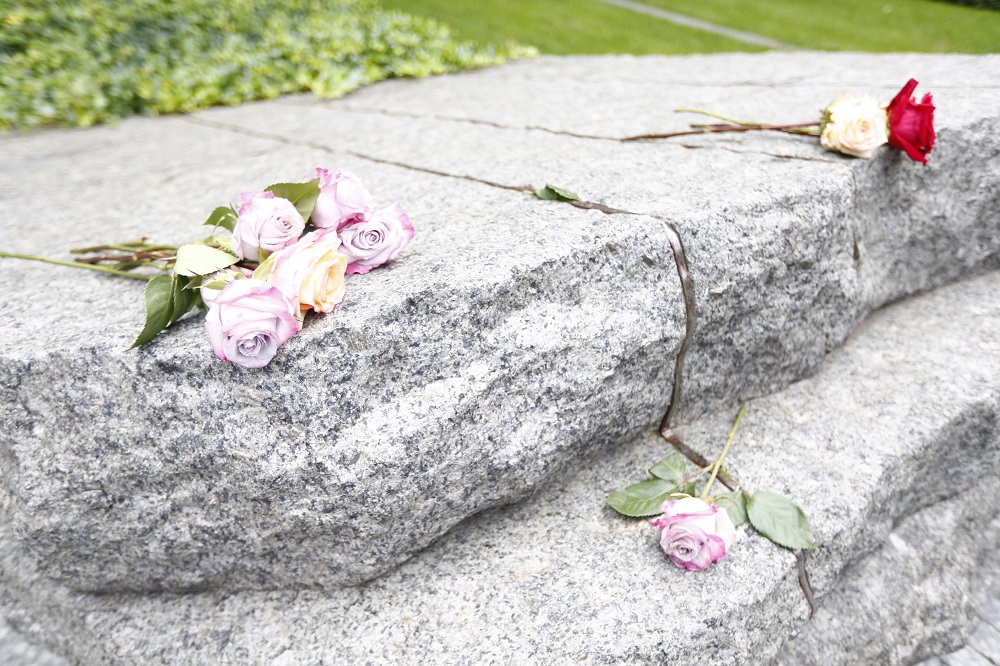 Flower tributes are left on the Memorial Glade.