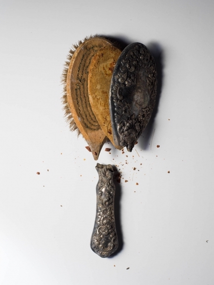 Charred, broken hair brush