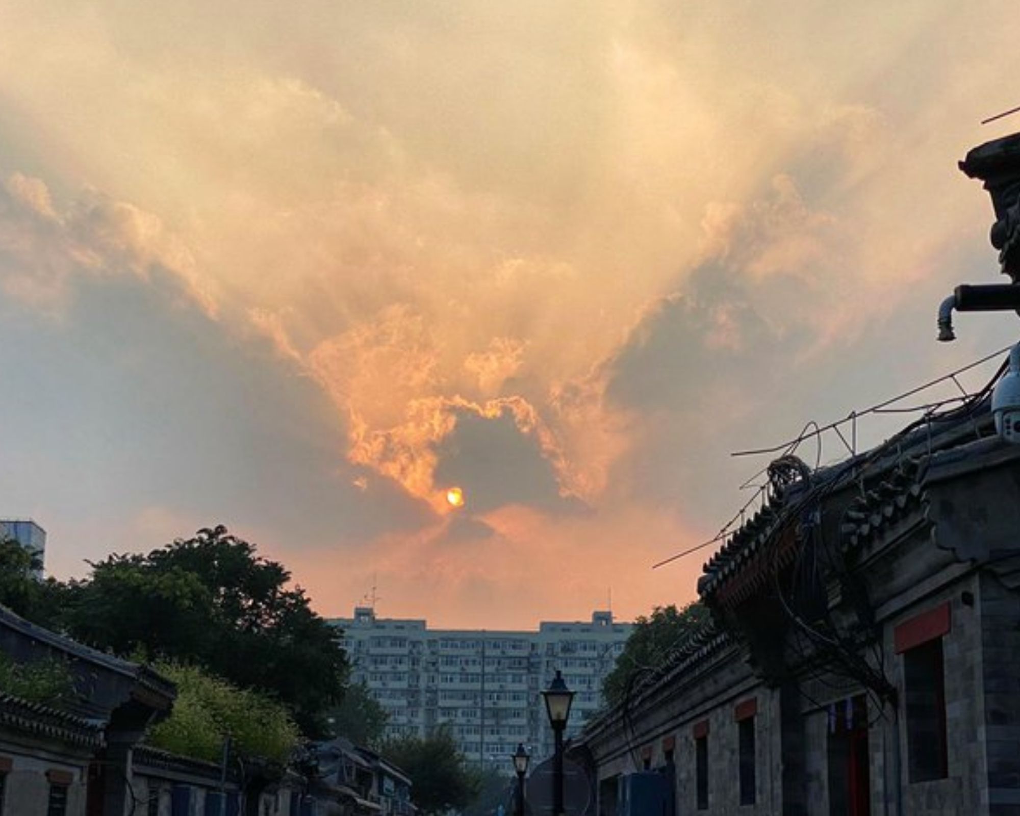 Hazy pastel sunset with buildings at forefront