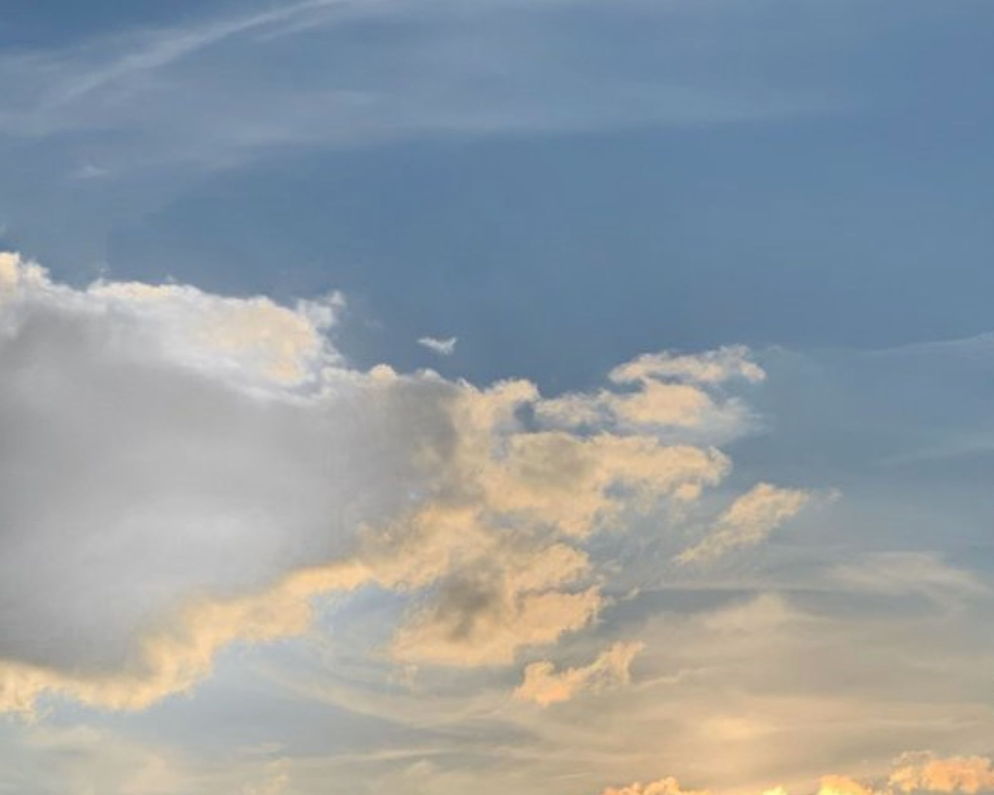 Feathery clouds against baby blue sky