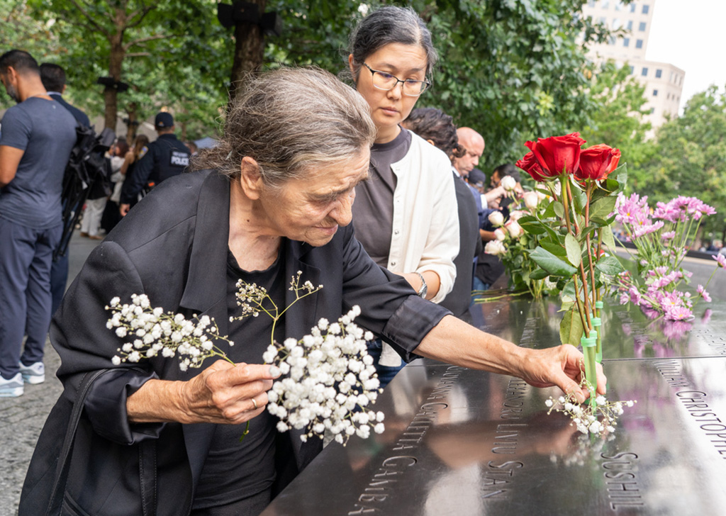 flowers are placed near loved ones' names on the Memorial