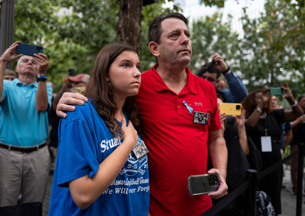 family members in solemn remembrance at the ceremony