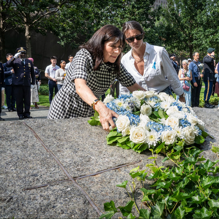 laying a wreath upon on of the Memorial Glade monoliths