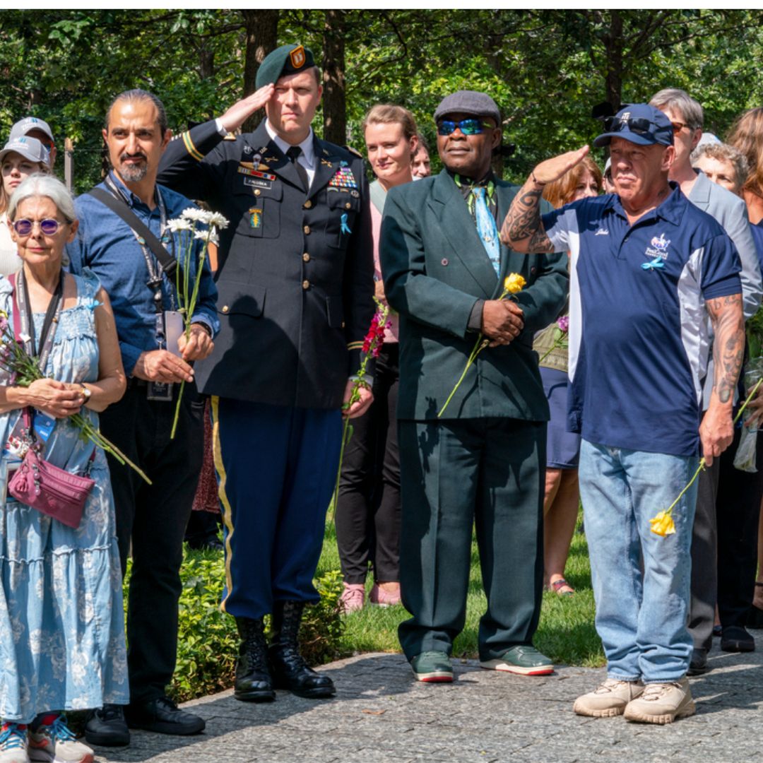 Guests salute the Memorial Glade