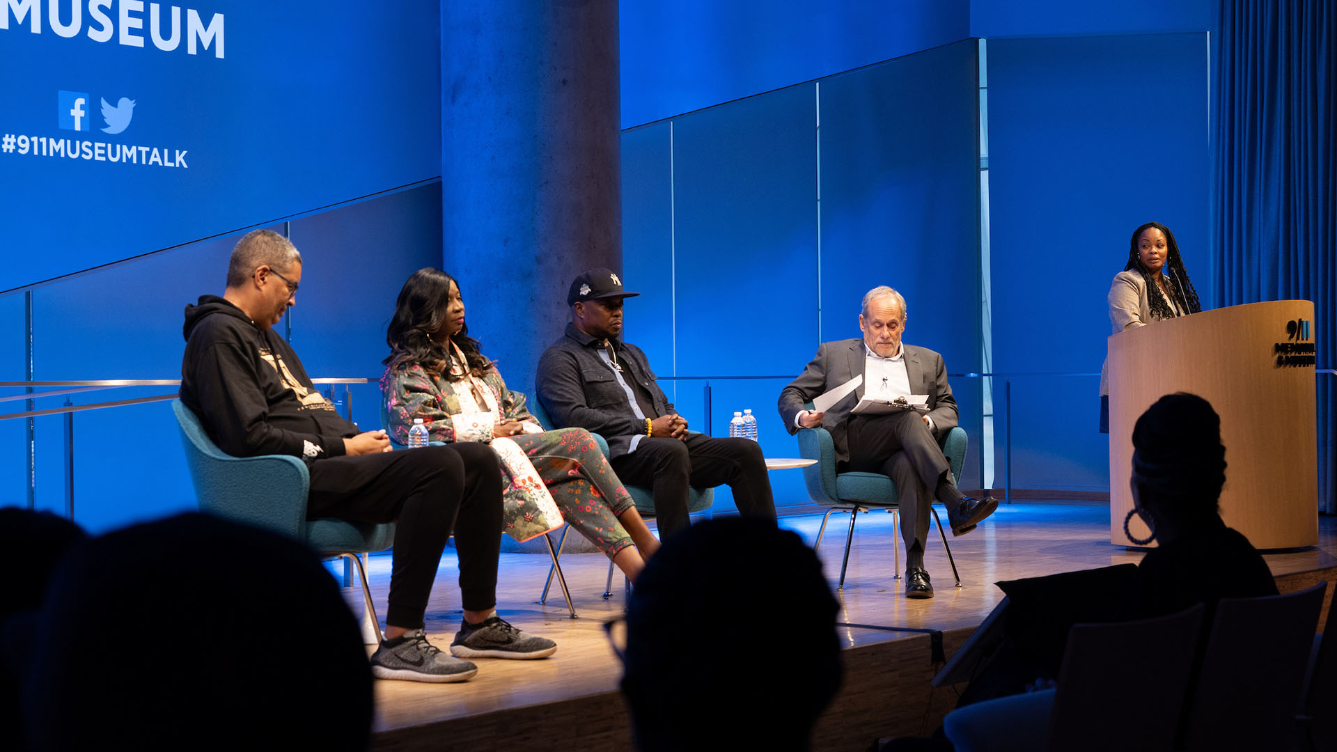 From left: Rocky Bucano, Dr. MC Debbie D, Chuck Creekmur, and Clifford Chanin on stage with Tiki Tolliver at podium