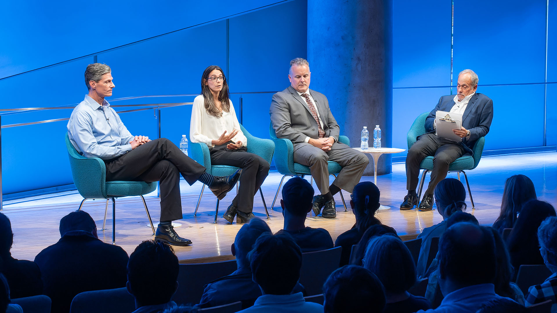 From left: Carl D. Gajewski, Jennifer K. Odien (talking), Mark Desire and Clifford Chanin on stage