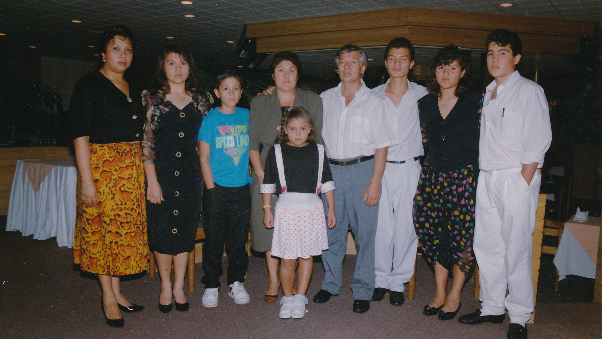 A family photo in front of banquet tables