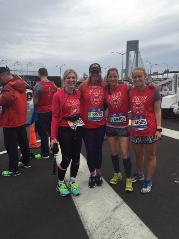 4 runners wear FDNY tshirts and their marathon runner numbers