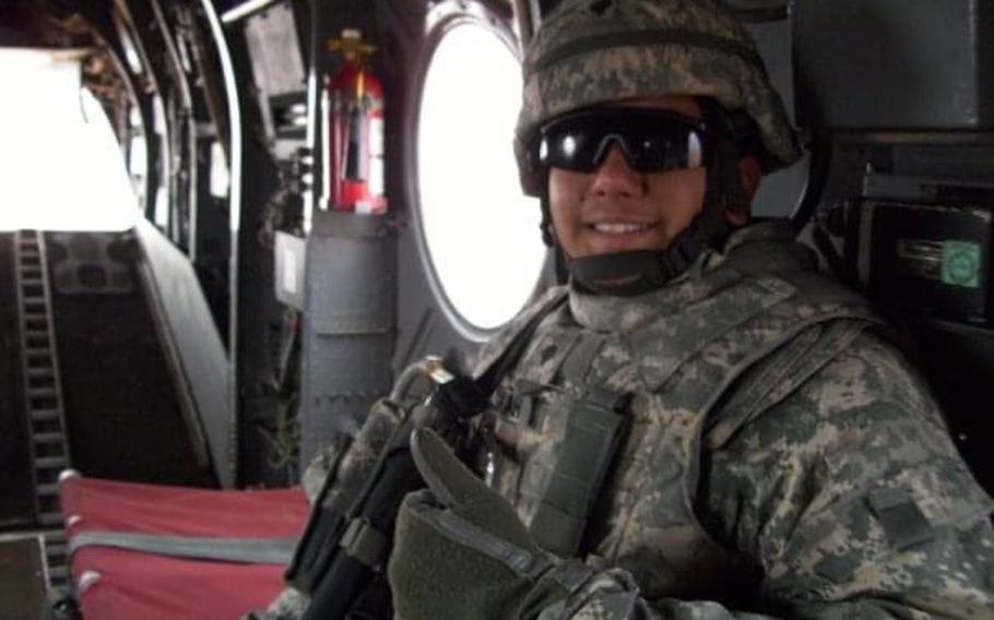 Naveed Shah smiles in army camouflage uniform, inside a military aircraft