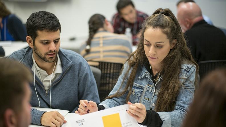 Two young adults are engaged in a learning activity in the 9/11 Memorial Museum's education center classrooms during a professional development day.