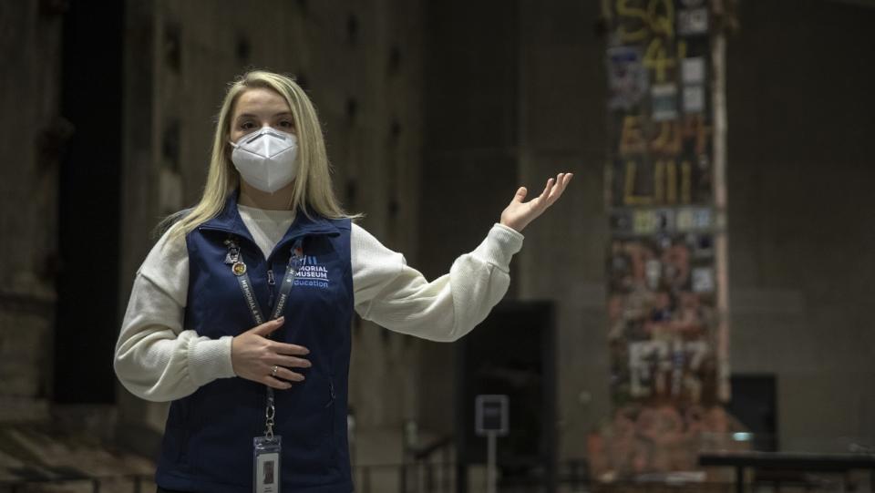 A young, blonde female docent gives a virtual tour of the "Revealed" exhibition space