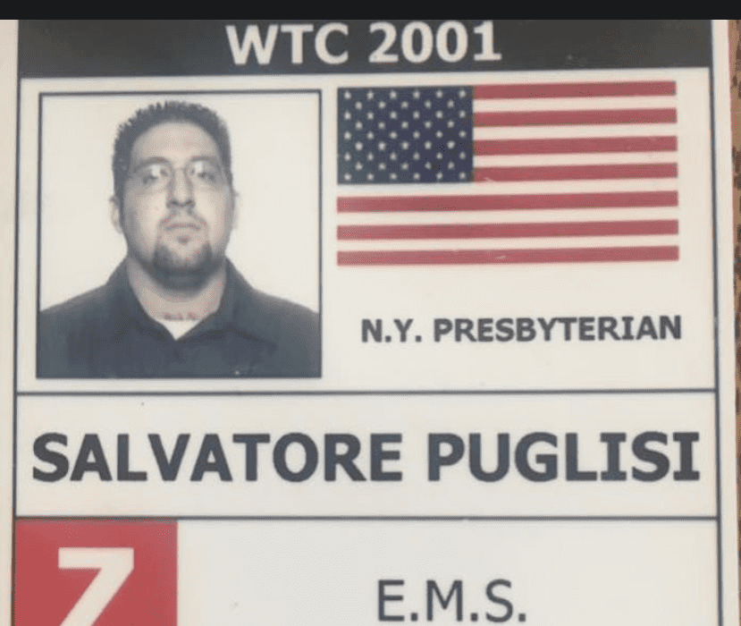 This hospital ID card belonging to Salvatore Puglisi to shows his photo in the upper lefthand corner and the American flag on the right. His name Salvatore Puglisi and the words EMS are below.